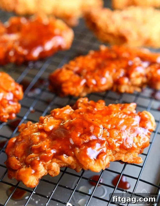 Sticky sweet Honey BBQ Chicken Strips are perfect for dinner or game day! Marinated in buttermilk and perfectly seasoned, these strips are hard to resist! | MomOnTimeout.com