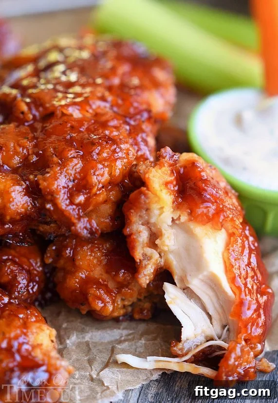Sticky sweet Honey BBQ Chicken Strips are perfect for dinner or game day! Marinated in buttermilk and perfectly seasoned, these strips are hard to resist! | MomOnTimeout.com