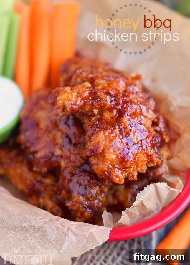 Sticky sweet Honey BBQ Chicken Strips are perfect for dinner or game day! Marinated in buttermilk and perfectly seasoned, these strips are hard to resist! | MomOnTimeout.com