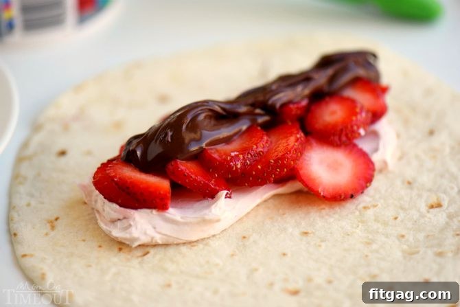 Crispy Chocolate Strawberry Cheesecake Chimis 4 Ingredients for Chocolate Strawberry Cheesecake Chimichangas being prepared on a cutting board.