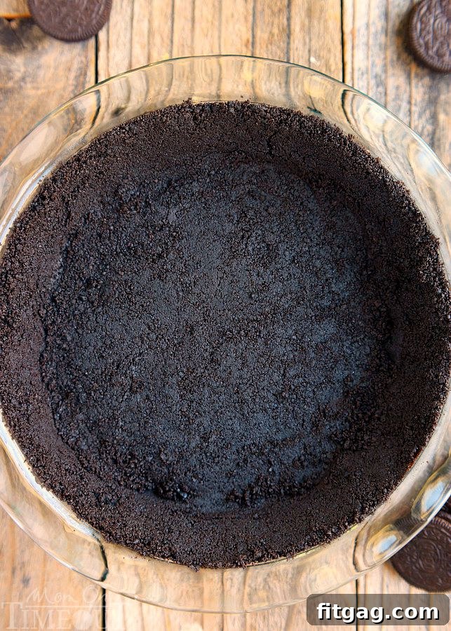 A close-up of the OREO cookie crust in a pie plate, perfectly pressed and ready for the filling.