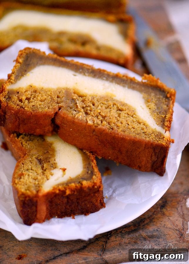 Close-up of a slice of Pumpkin Cheesecake Banana Bread with a visible cheesecake swirl