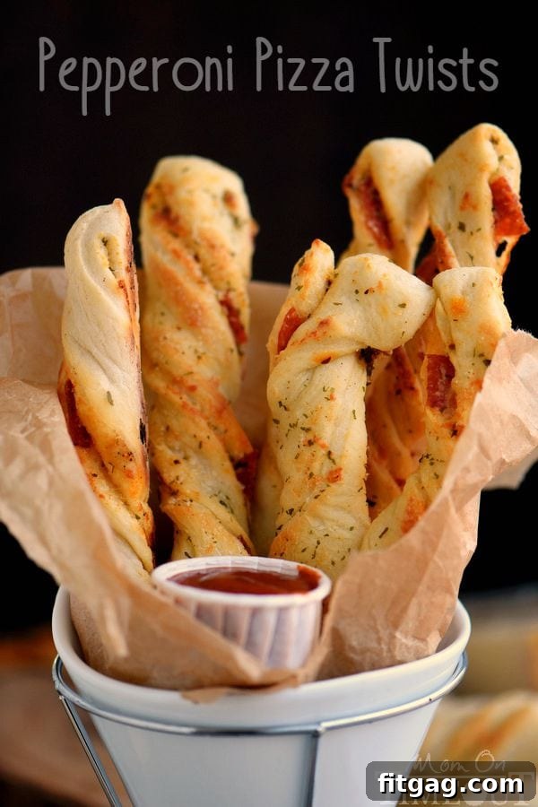 Savory Pepperoni Pizza Spirals 2 Close-up of baked Pepperoni Pizza Twists, golden brown and cheesy, on a white plate ready for serving