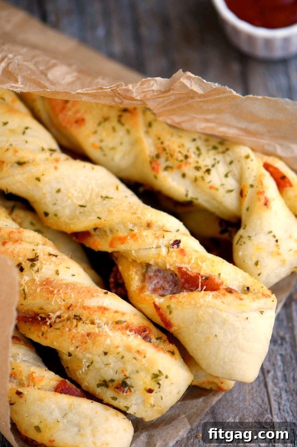 Savory Pepperoni Pizza Spirals 3 Ingredients for Pepperoni Pizza Twists laid out on a cutting board, including pizza dough, pepperoni, and cheese