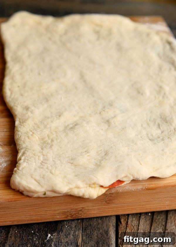 Savory Pepperoni Pizza Spirals 5 Unbaked pizza dough folded over with pepperoni and cheese inside, cut into strips before twisting