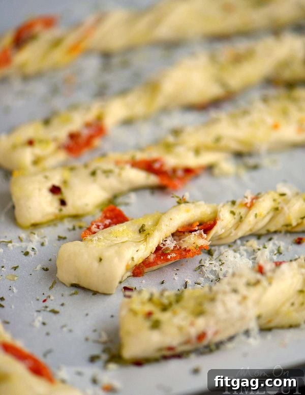 Savory Pepperoni Pizza Spirals 6 Freshly baked Pepperoni Pizza Twists cooling on a wire rack, steam gently rising