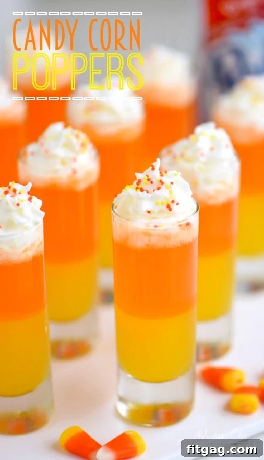 Brightly colored Candy Corn Poppers in elegant shot glasses, perfect for a festive occasion.