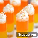 A small image of Candy Corn Poppers with whipped cream topping.
