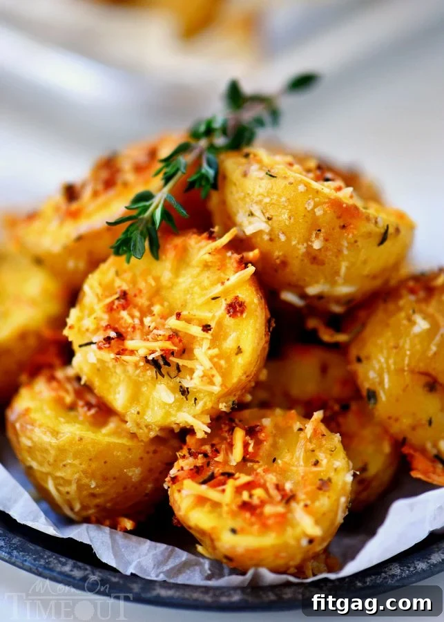 Close-up of golden brown oven roasted potatoes with herbs and garlic