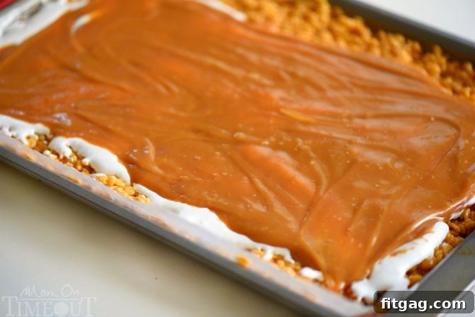 Preparing caramel pumpkin spice pinwheels, showing the rice krispies mixture flattened and ready for rolling.