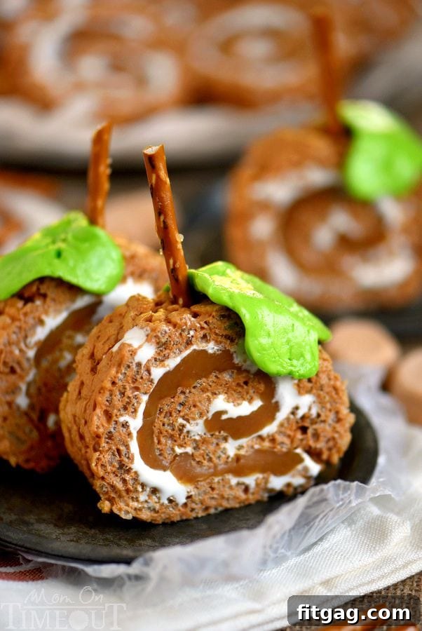 Finished Caramel Pumpkin Spice Rice Krispies Treats Pinwheels decorated like pumpkins with pretzel stems and laffy taffy leaves, ready to enjoy.