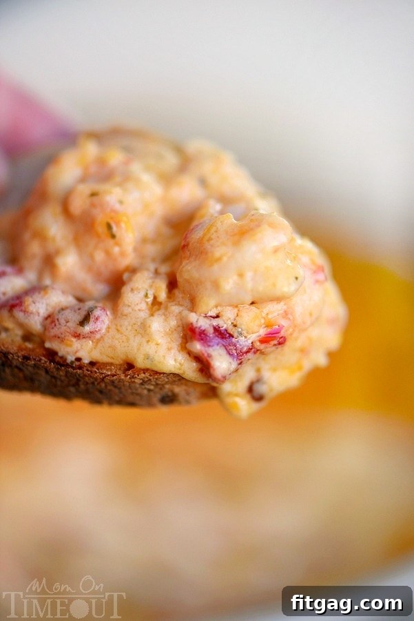 Close-up of the bubbly and golden-brown Roasted Red Pepper Shrimp Scampi Dip fresh from the oven