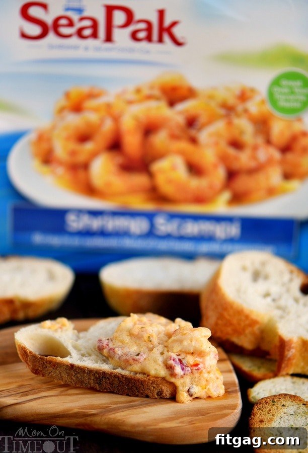 A dish of Roasted Red Pepper Shrimp Scampi Dip with crackers and fresh parsley, ready for serving