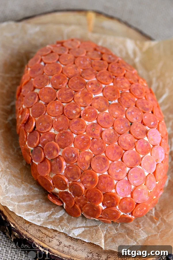 This Pepperoni Pizza Football Cheese Ball is my new favorite thing! Super easy to make and a total showstopper! Make this for your next game day celebration and watch the crowd go wild!