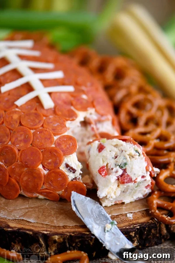 This Pepperoni Pizza Football Cheese Ball is my new favorite thing! Super easy to make and a total showstopper! Make this for your next game day celebration and watch the crowd go wild!