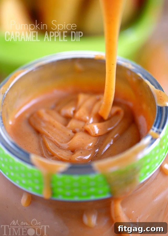 Rich Pumpkin Spice Caramel Apple Dip in a serving bowl, surrounded by fresh apple slices, ready for dipping.
