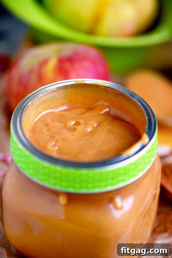 A charming glass jar filled with homemade Pumpkin Spice Caramel Apple Dip, adorned with a ribbon, perfect for gifting.