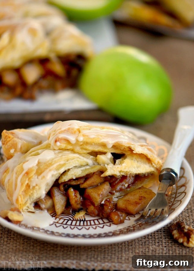 Freshly baked Apple Walnut Strudel, sliced and served on a white plate with a side of coffee, perfect for breakfast or dessert.