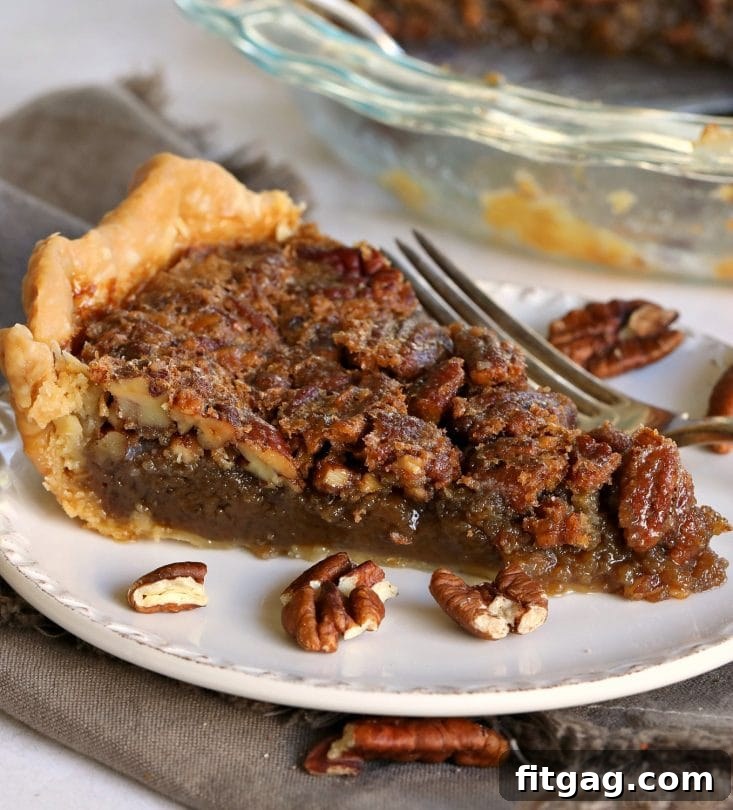 Decadent Brown Sugar Pecan Pie 3 A slice of brown sugar pecan pie showing the rich, gooey filling and perfectly chopped pecans.