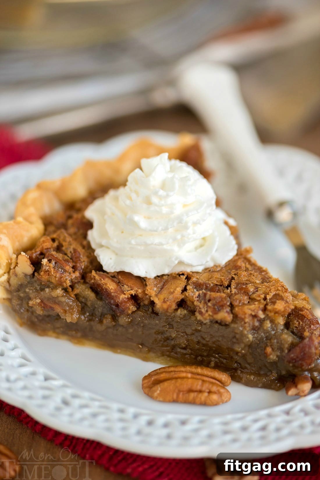 Decadent Brown Sugar Pecan Pie 6 A slice of brown sugar pecan pie on a white plate, showcasing its rich, golden-brown crust and gooey filling with chopped pecans.