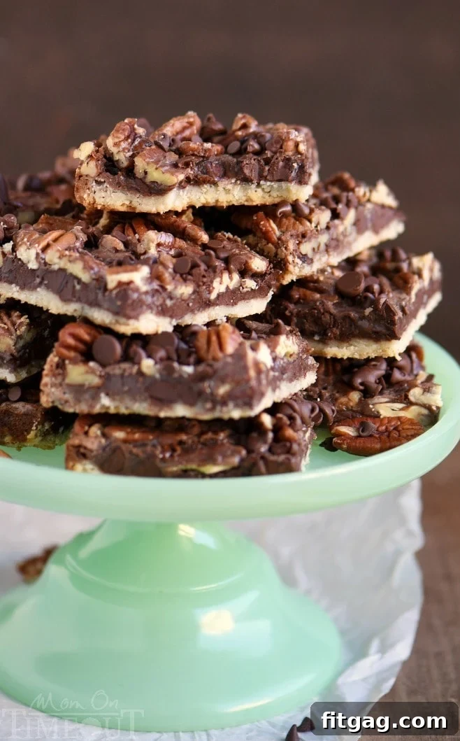 Close-up of a chocolate pecan pie bar with a bite taken out, showing the gooey chocolate and pecan filling and golden crust. An easy holiday dessert recipe.