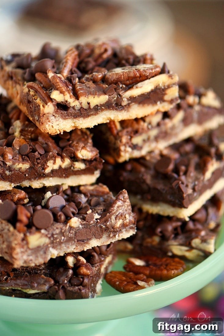Detailed close-up of several chocolate pecan pie bars, highlighting the rich chocolate, whole pecans, and flaky crust. A perfect holiday baking recipe.