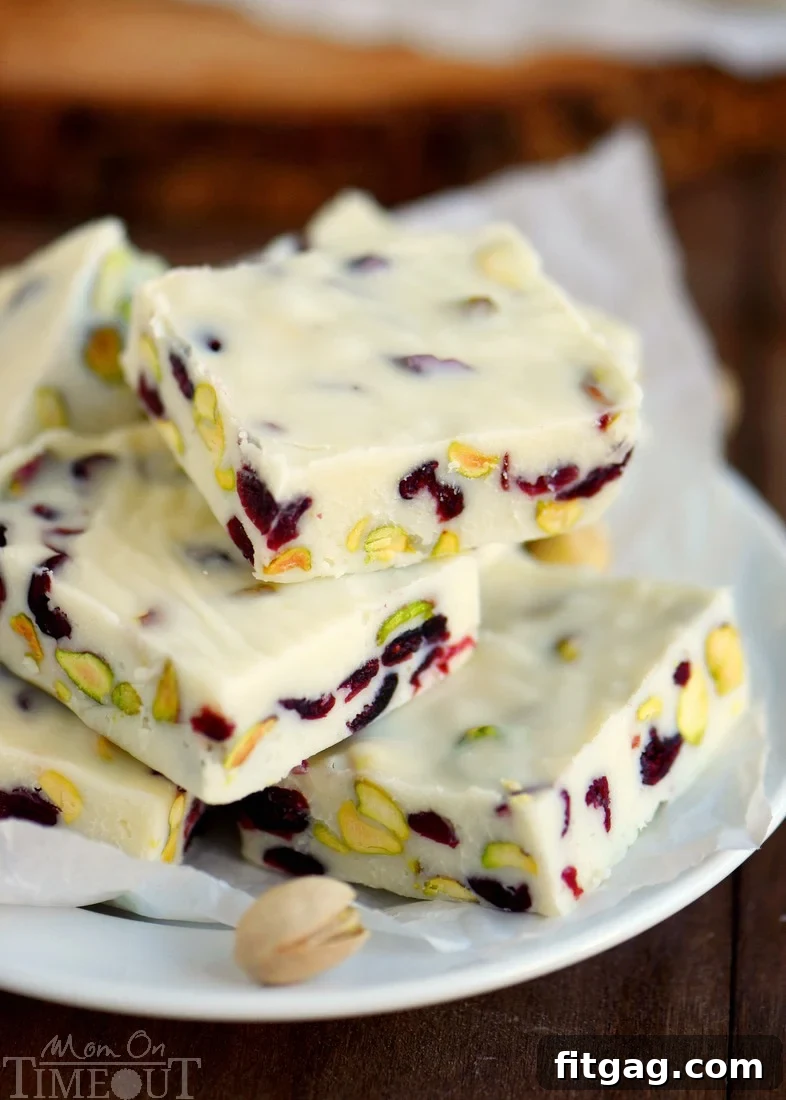 Close-up of cranberry pistachio fudge squares on a serving plate