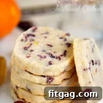 shortbread cookies stacked on white plate with one cookie leaning against the stack