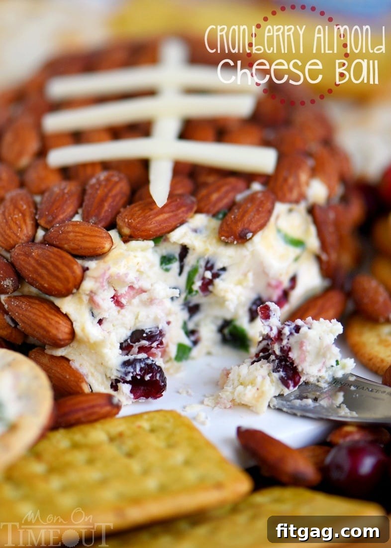 A vibrant platter featuring the Cranberry Almond Cheese Ball, with various crackers and grapes, ready for a party spread.