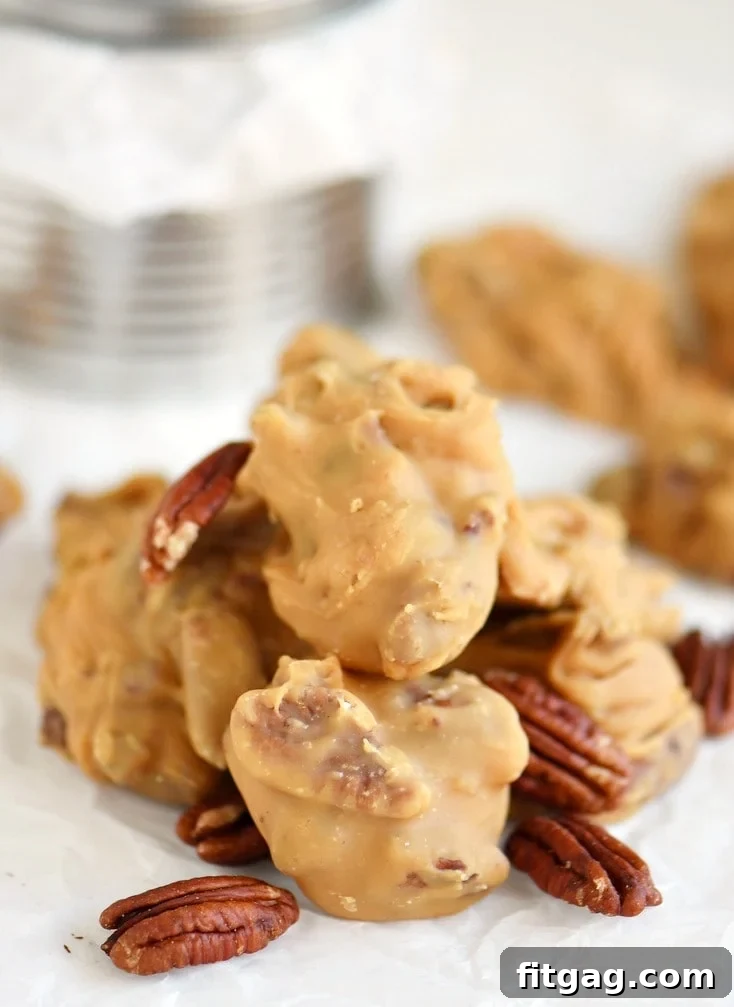 Close-up view of freshly made Buttermilk Pecan Pralines on wax paper, showing their irregular, artisanal shape.
