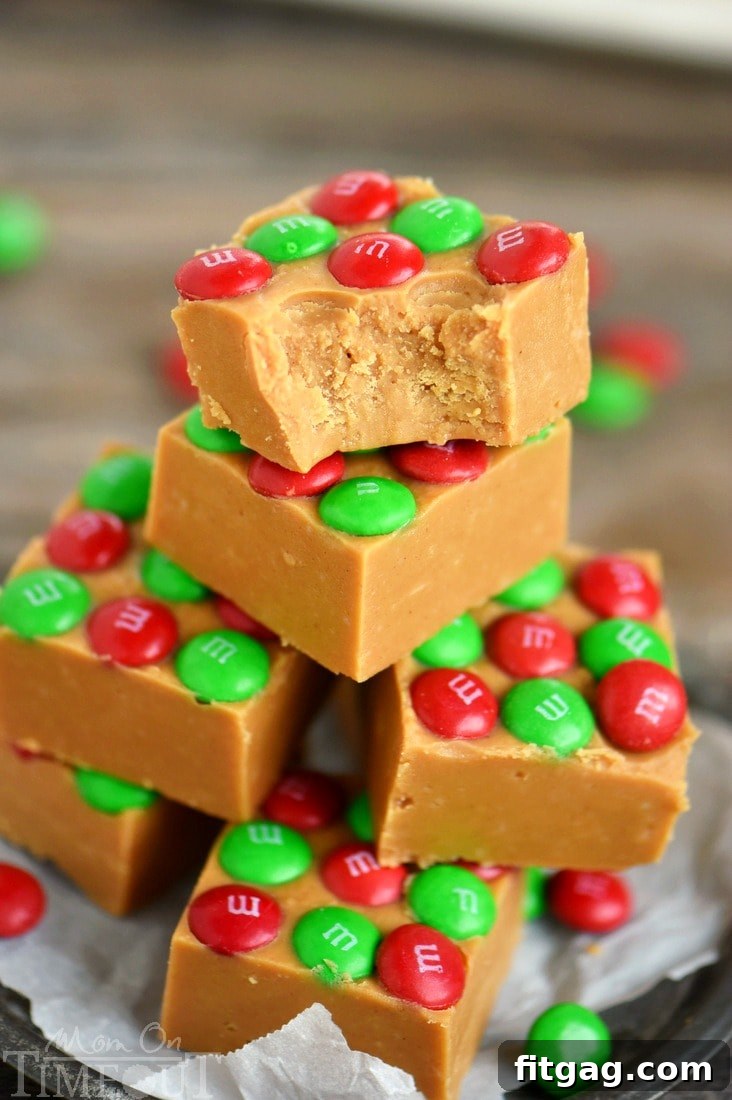 Peanut Butter Fudge with a bite taken out, showing its creamy texture and M&Ms