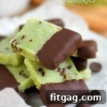 mint shortbread cookies dipped in chocolate and arranged on a white plate, ready to be enjoyed.
