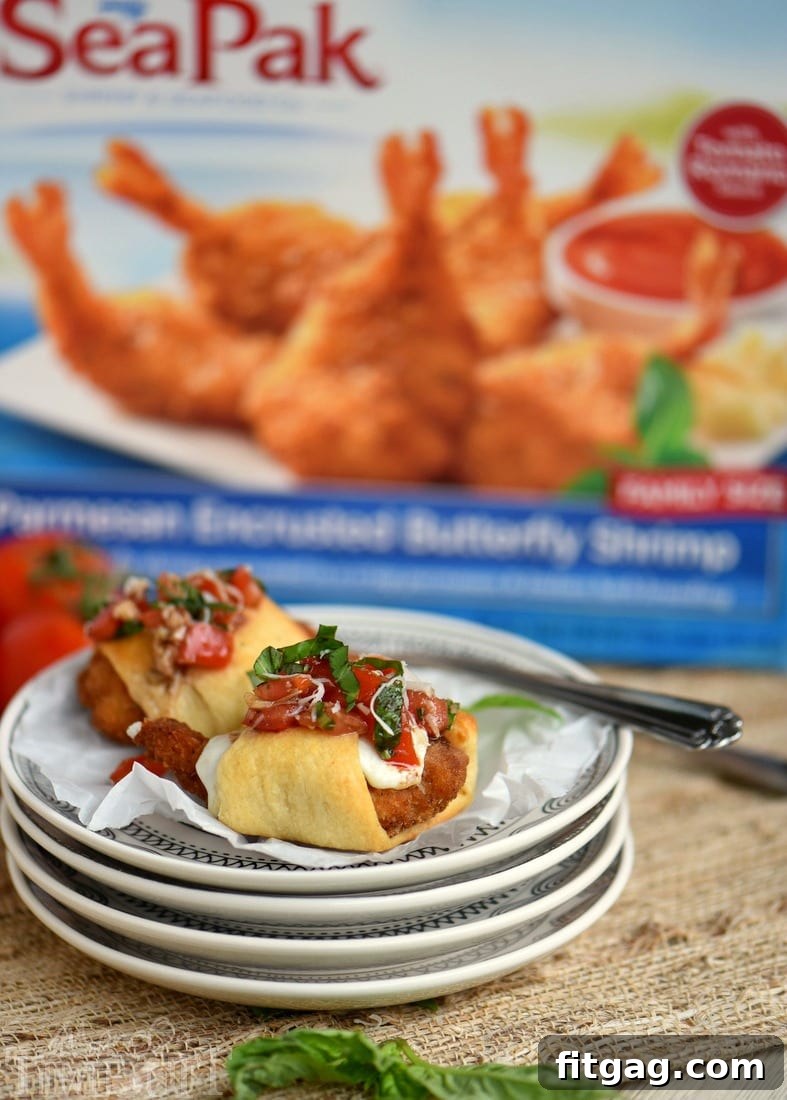 Parmesan Shrimp Crostini 4 A serving platter filled with golden-brown Parmesan Shrimp Bruschetta Bites, each topped with a generous spoonful of vibrant red and green bruschetta.