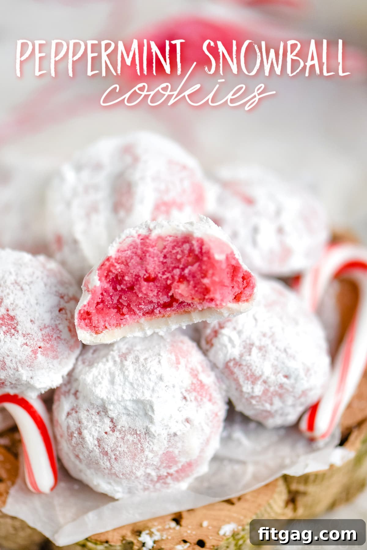 peppermint snowball cookies in a pile with one cookie broken in half showing the pink interior with title overlay at top of image