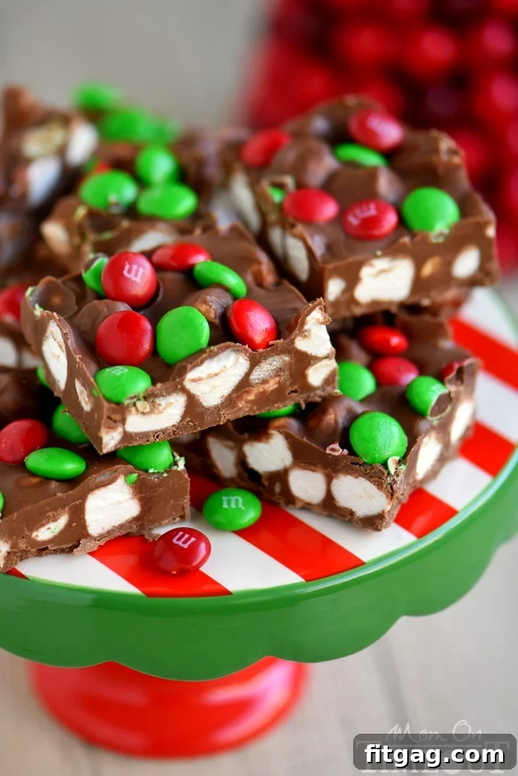 M&Ms Cloud Nine Marshmallow Bars 5 A tray of freshly made M&M's Marshmallow Dream Bars, topped with colorful candies, ready to be refrigerated. This image highlights the quick assembly process and vibrant appeal of the no-bake dessert.