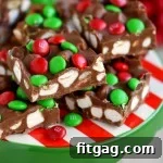 M&Ms Cloud Nine Marshmallow Bars 6 A close-up of a single M&M's Marshmallow Dream Bar, showing the colorful candies, chewy marshmallows, and rich chocolate-peanut butter base.