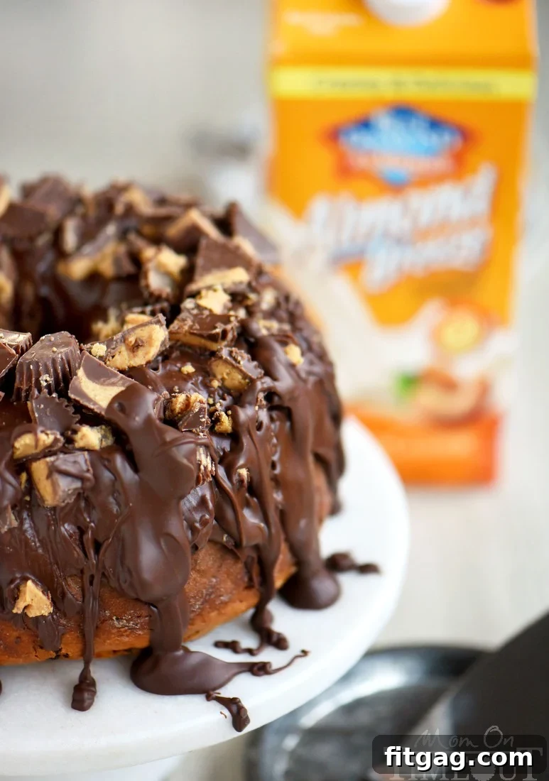 A beautifully glazed Reese's Peanut Butter Chocolate Chip Pound Cake on a cooling rack