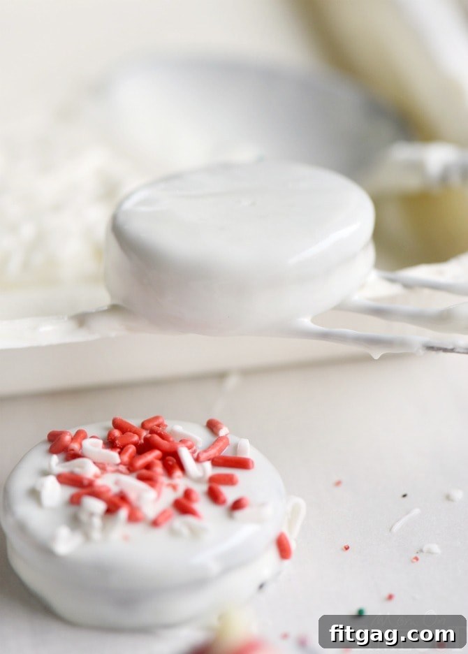 Various dipping tools and bowls of sprinkles ready for decorating Holiday Dipped Oreos.