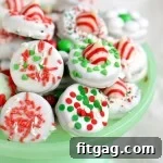 Decorated dipped Oreo cookies for Christmas on a green cake stand