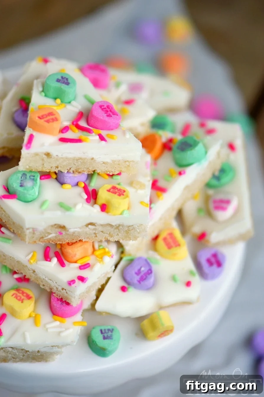 Sweet Talk Sugar Cookie Bark 5 A stack of colorful Conversation Heart Sugar Cookie Bark pieces, perfect for gifting or sharing.