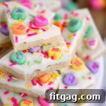 conversation heart sugar cookie bark decorated for valentines day stacked on top of each other on a white cake stand.