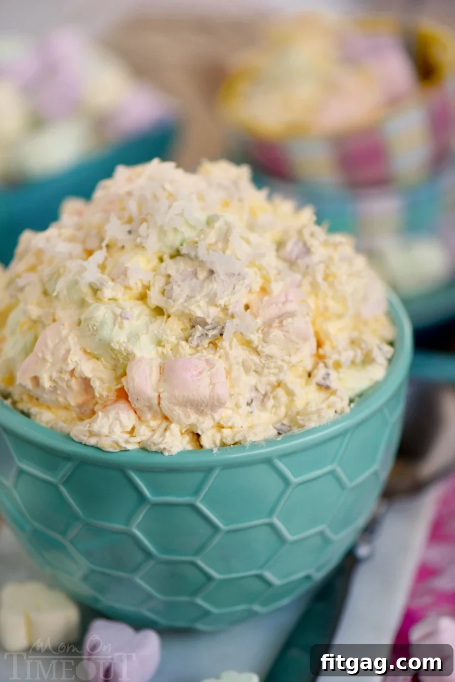 A close-up of Easter Fluff, a light and airy dessert salad made with colorful marshmallows and a creamy base, served in an elegant bowl.
