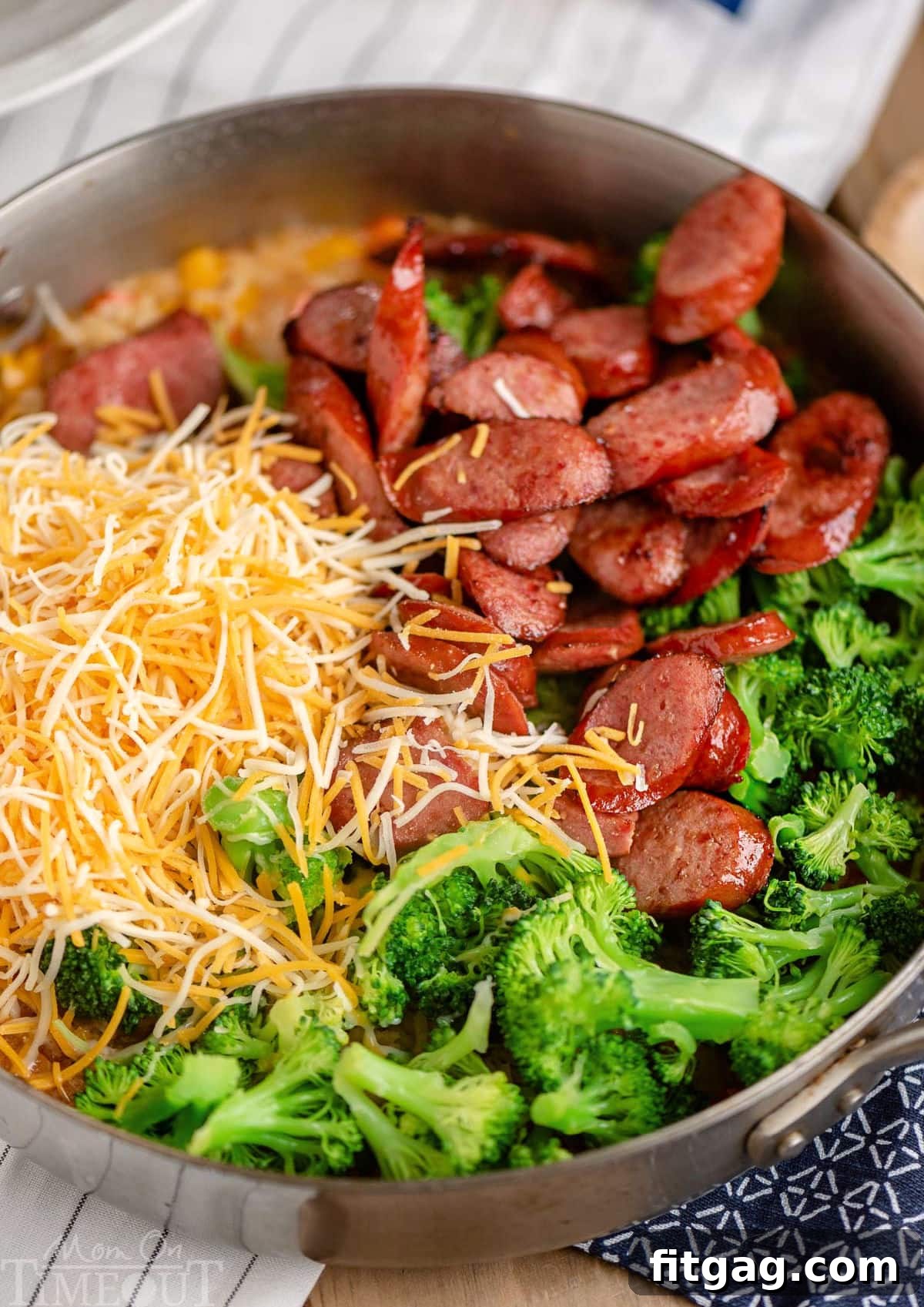 One-Skillet Cheesy Kielbasa and Broccoli Rice 3 Top down look at kielbasa skillet ingredients in the skillet ready to be stirred in.