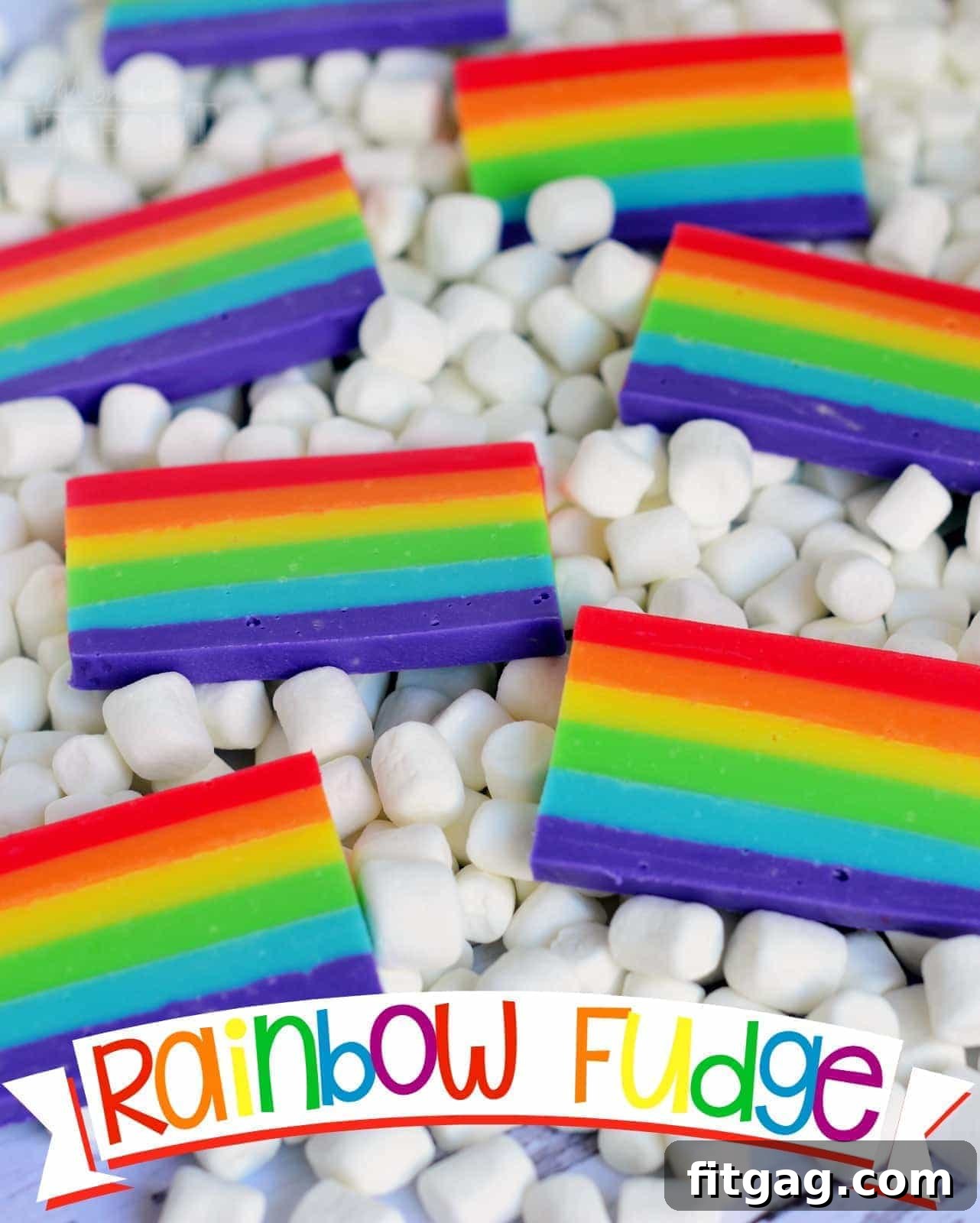 Delicious layered rainbow fudge slices, perfect for St. Patrick's Day or birthdays, served on a white plate with marshmallow clouds.