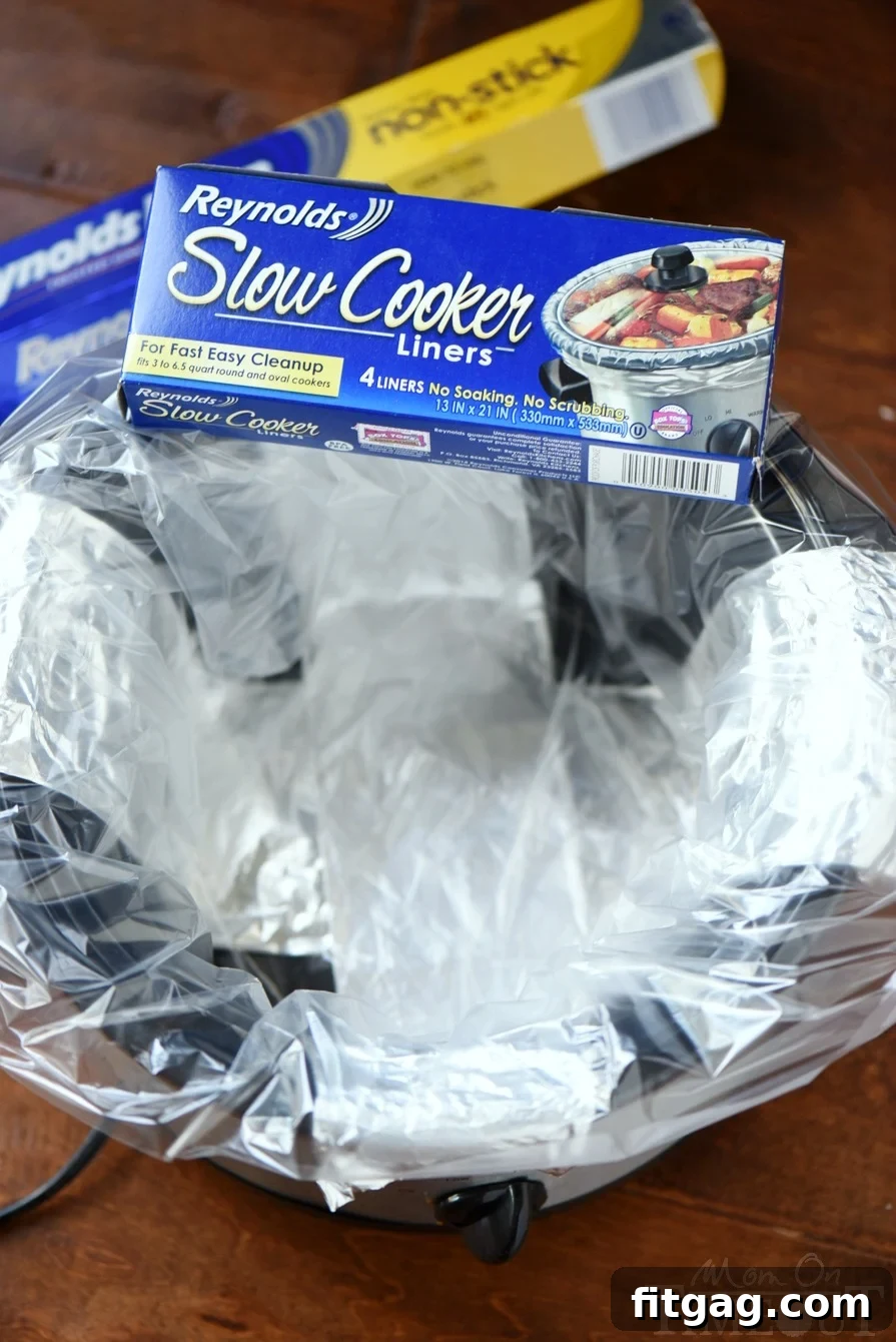 Decadent Slow Cooker Carrot Cake with Cream Cheese Swirl 4 Close-up of a slow cooker insert lined with a Reynolds liner, showcasing the convenience for baking and easy cleanup.