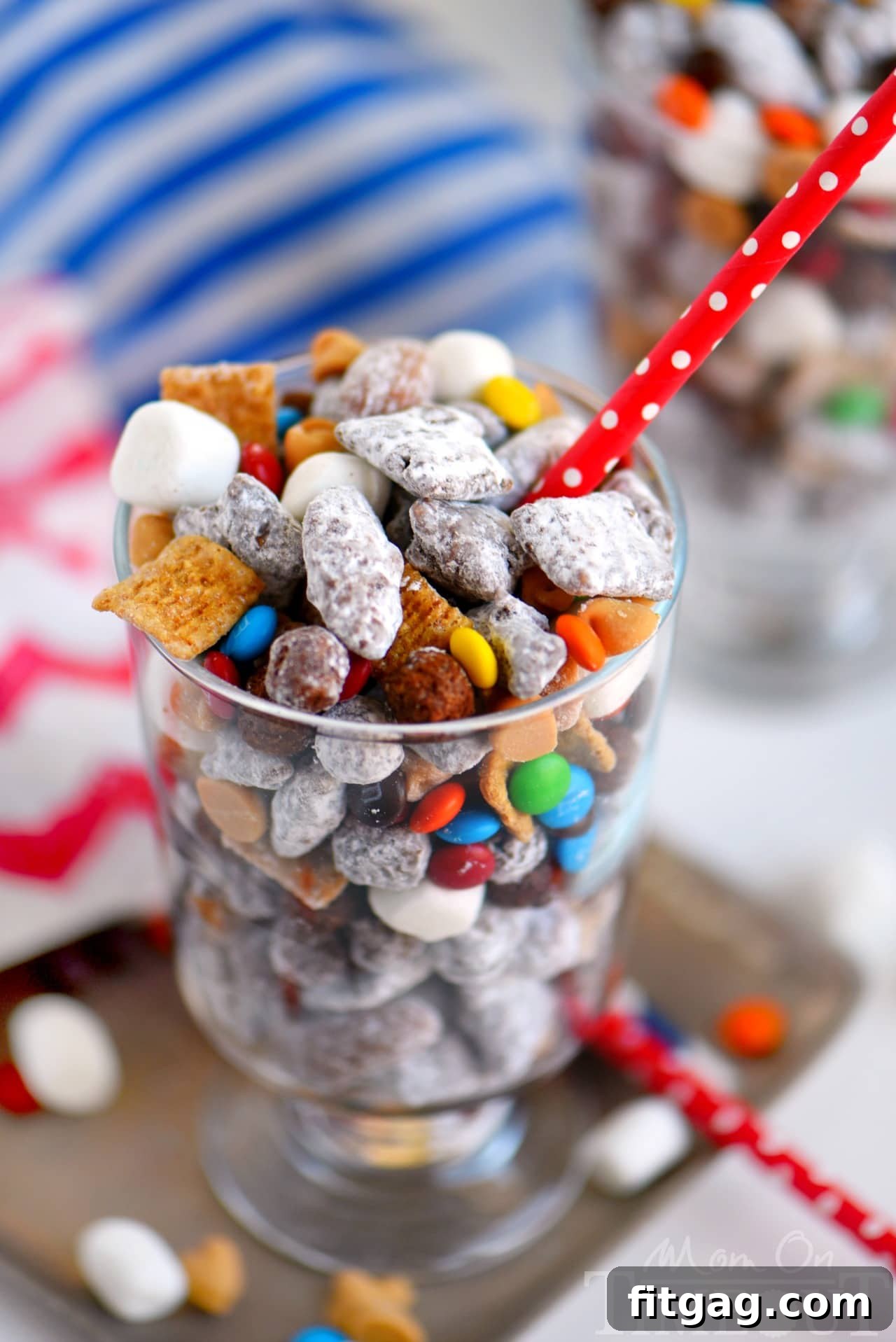 Close-up of a bowl filled with Monster S'mores Muddy Buddies, highlighting the peanut butter and chocolate coating.