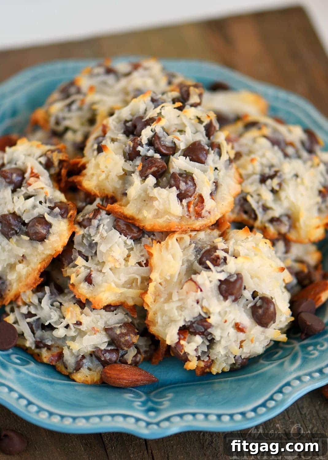 Close-up of baked Almond Joy Cookies, showing the golden brown edges of coconut flakes and melted chocolate chips