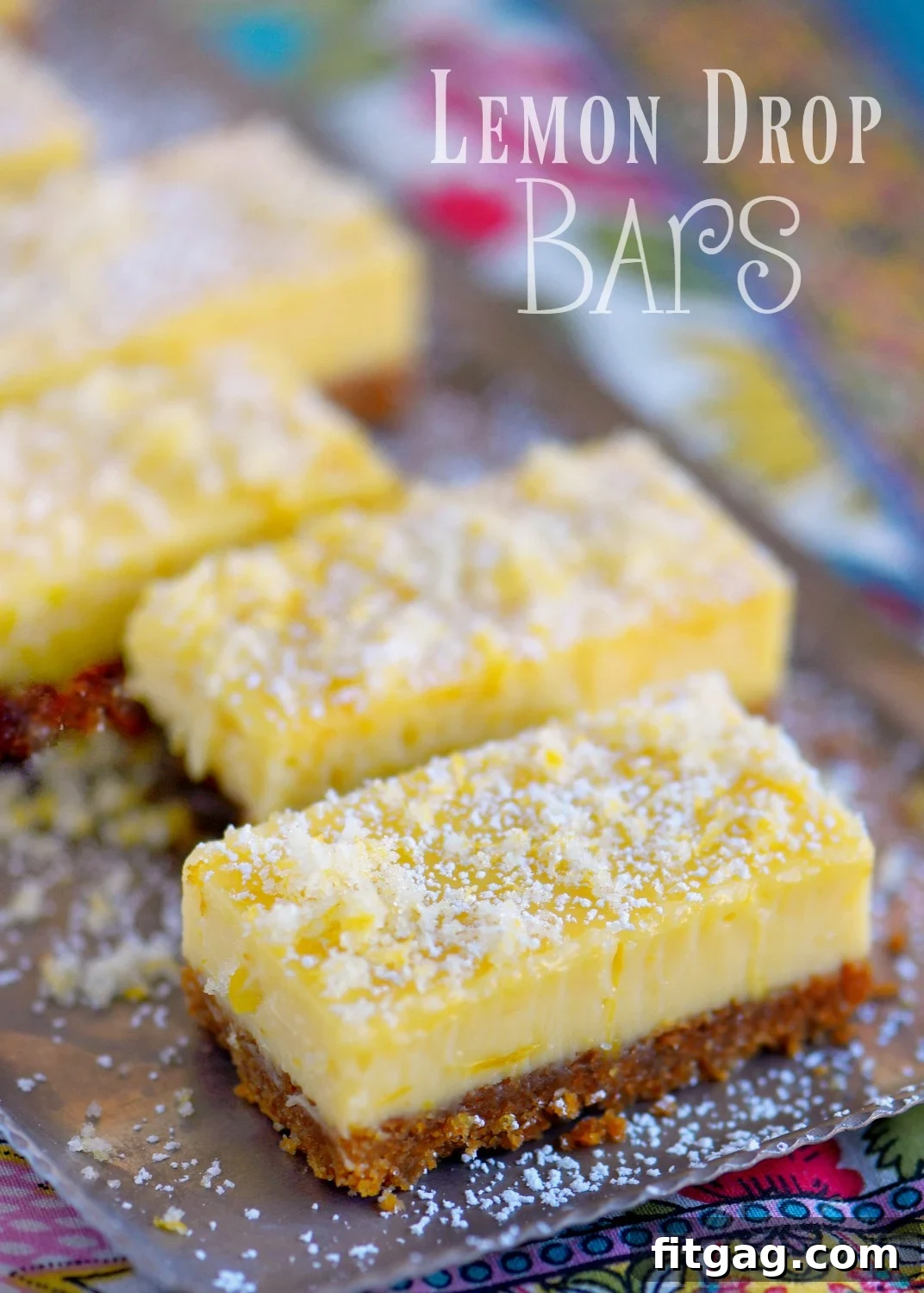 Creamy Lemon Drop Bars topped with glittering candied lemon zest, showcasing their irresistible sweet and tart appeal.