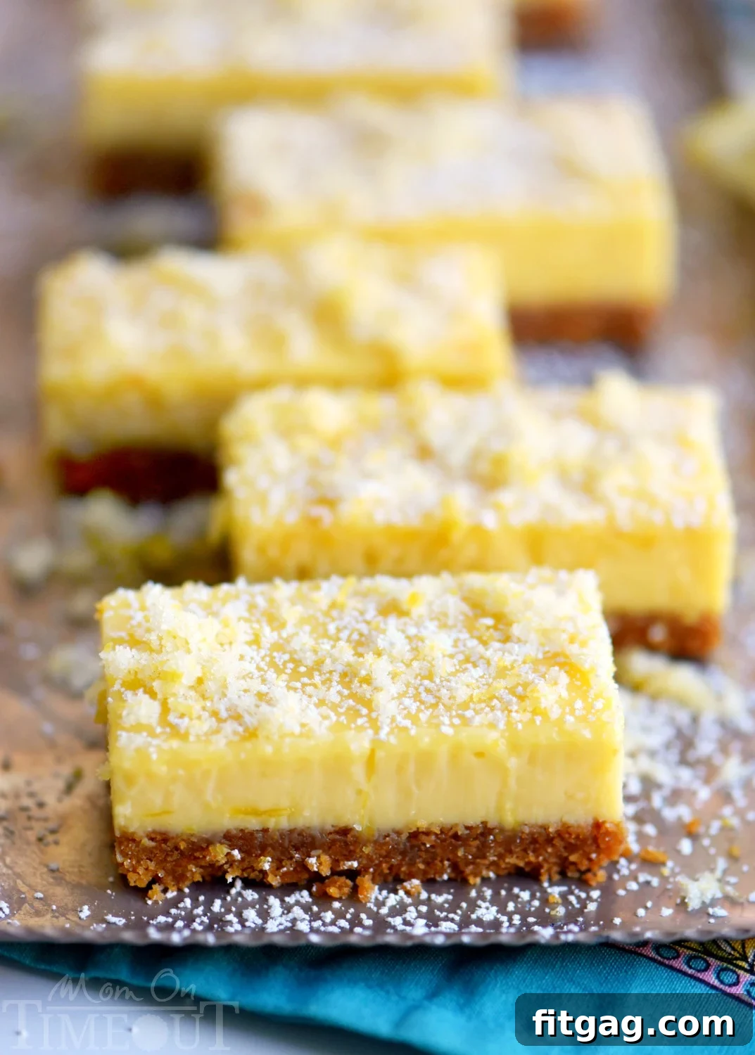 Close-up of Lemon Drop Bars revealing the thick, creamy lemon filling and the intricate texture of the candied lemon zest on top.