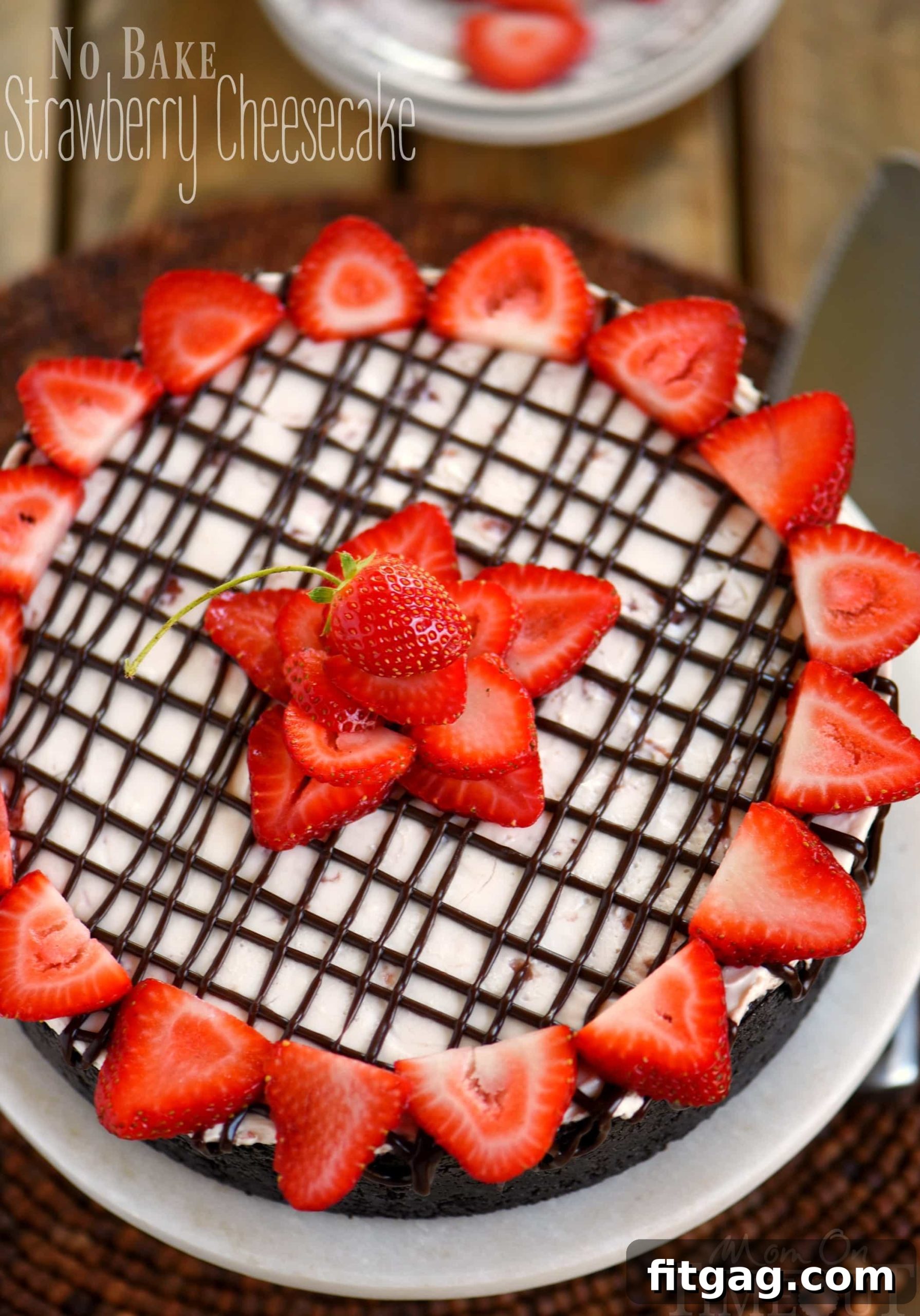 Strawberry Cloud Cheesecake 2 Decadent No-Bake Strawberry Cheesecake with OREO cookie crust, chocolate ganache, and creamy strawberry filling, garnished with fresh strawberries.